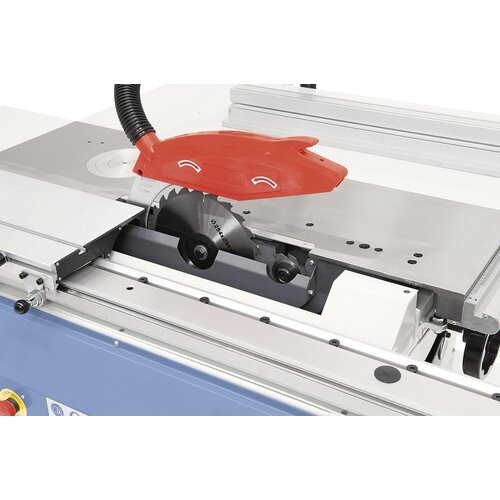 Sawblade cover with integrated dust port positioned at riving knife. Scoring unit is part of equipment.