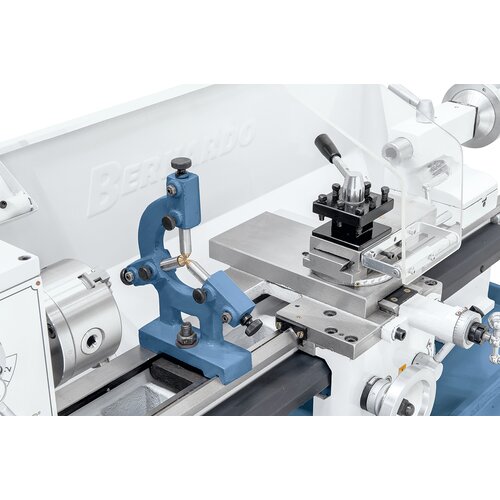 Steady rest with bronze guiding supports long workpieces. 