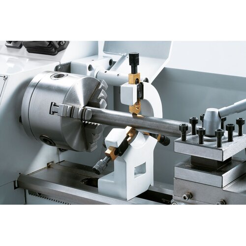 Steady rest with bronze guides to stabilize long workpieces.